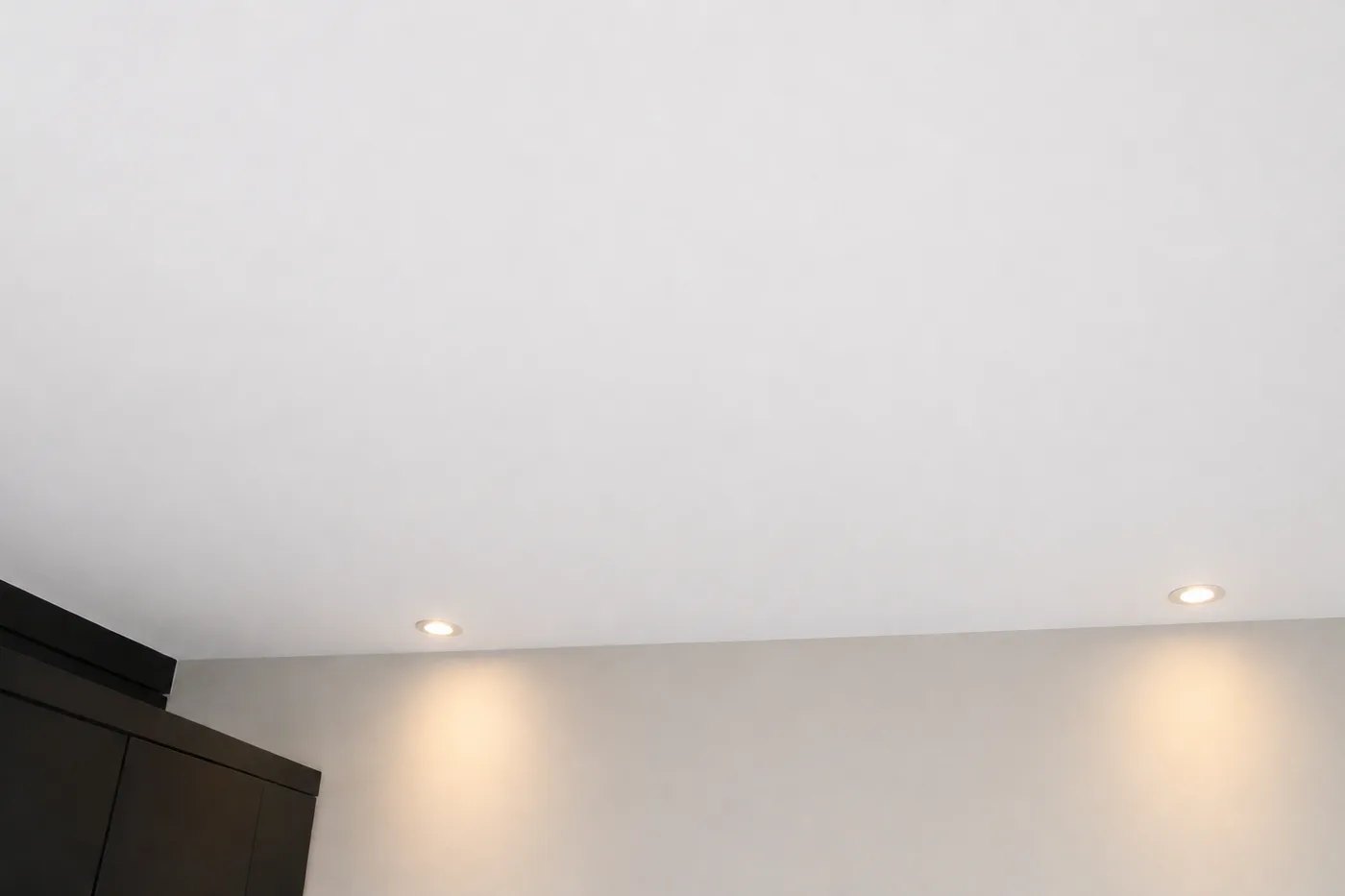 The same bedroom ceiling sealed and repainted, with the stain gone