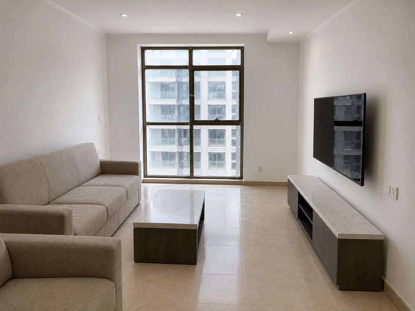 A finished apartment living room with clean white walls and a cut in ceiling line